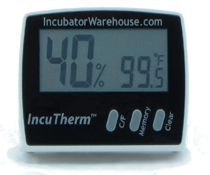 External incubator-style digital temperature and humidity monitor used to check cabinet dryer conditions.