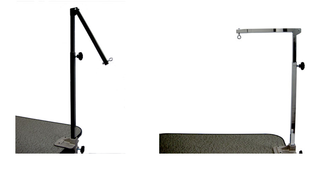Folding grooming arms with upper sections that swing out of the way above a dog grooming table.